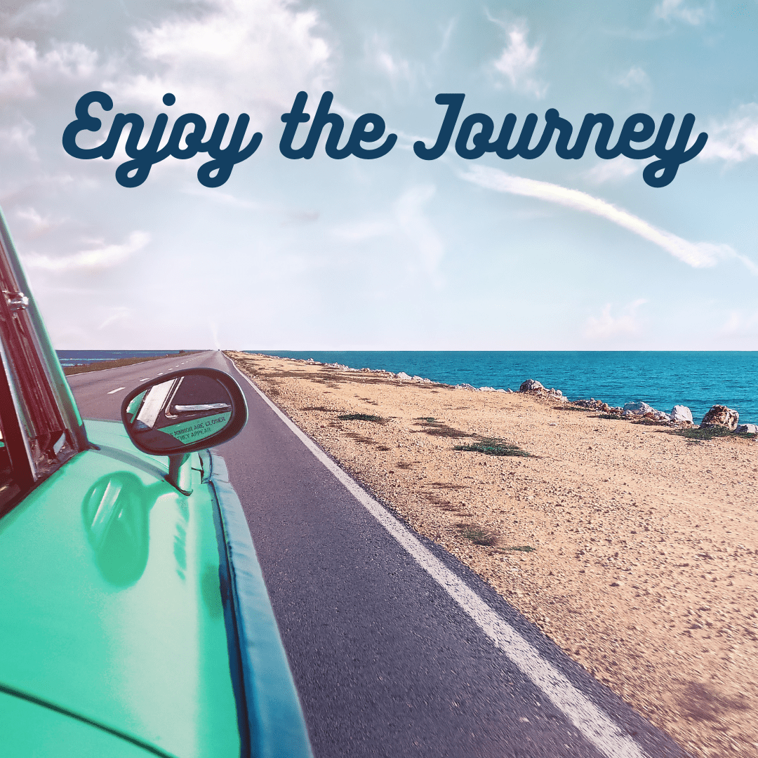 A bus driving down the road with the words " enjoy the journey ".